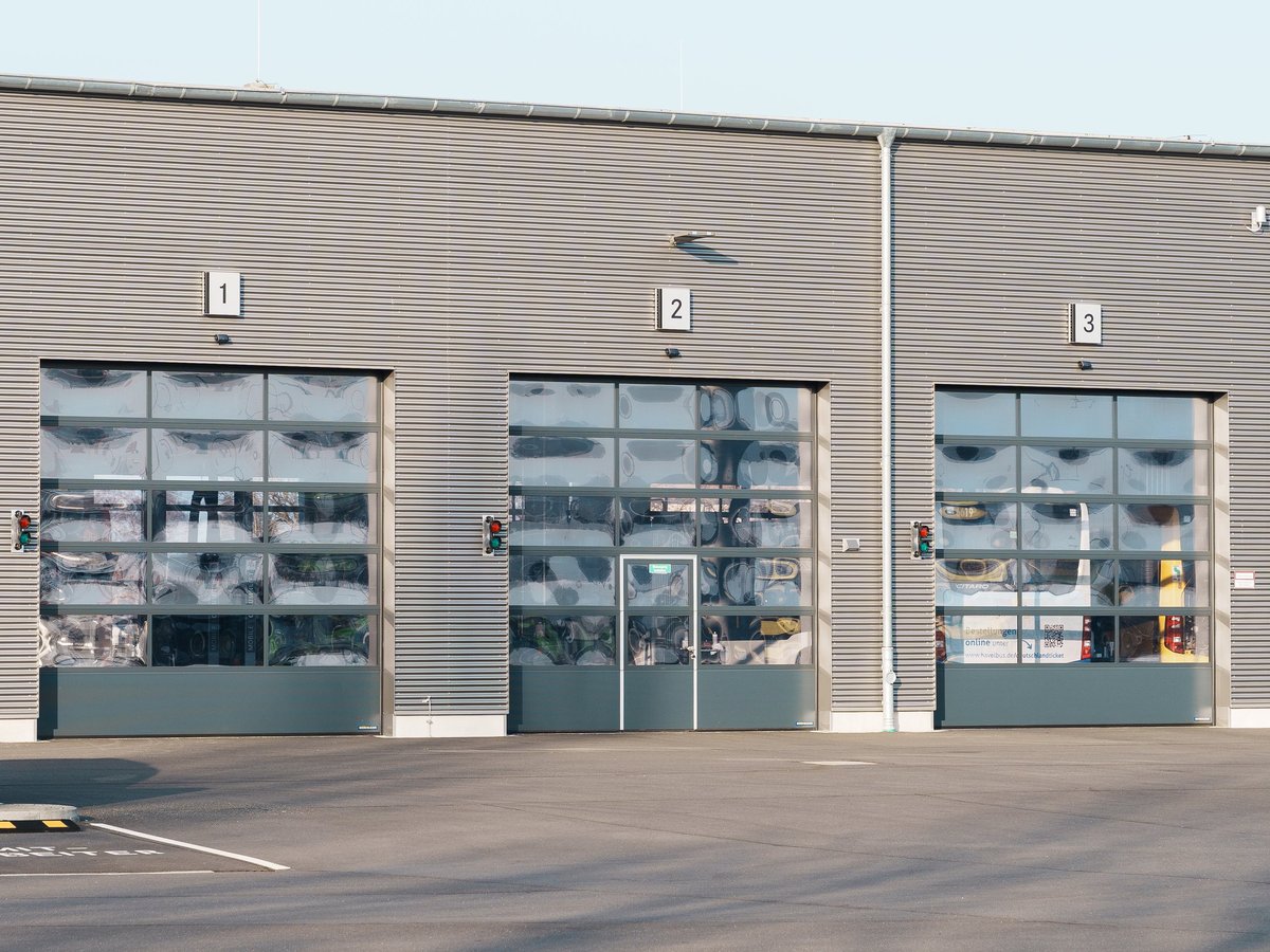Workshop building with transparent roller doors