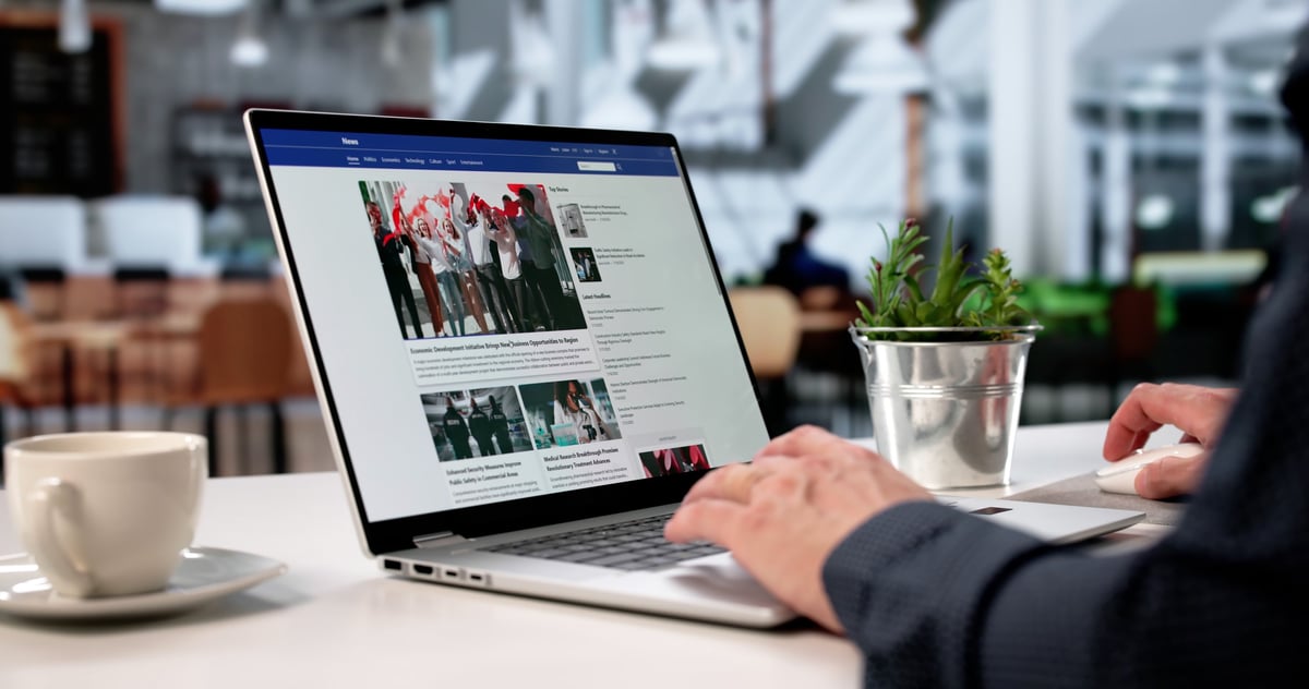 News website design on laptop showing articles